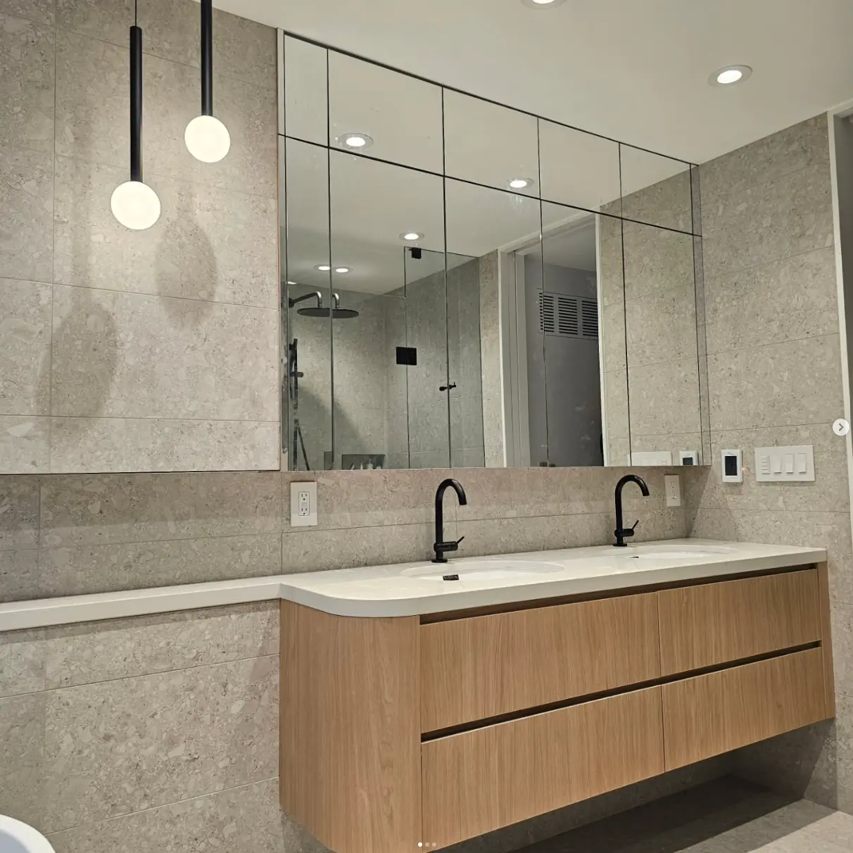 Custom bathroom vanity with mirror wall by Pine Kitchen Design
